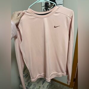 Pink Nike Dri-FIT long-sleeve running top.